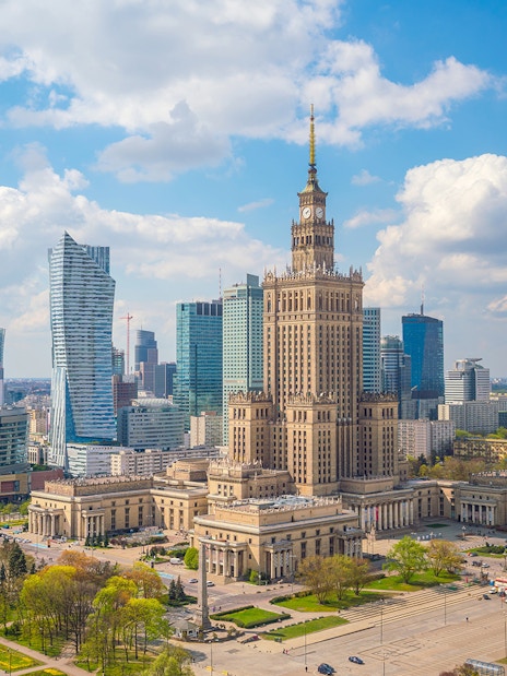 Palace of Culture and Science in Warsaw with surrounding skyscrapers.