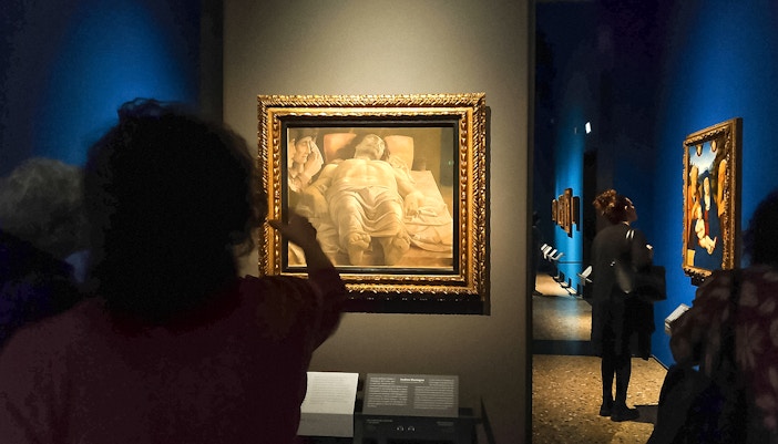 Visitors admire paintings, including Lamentation over the Dead Christ, at the Pinacoteca di Brera in Milan.