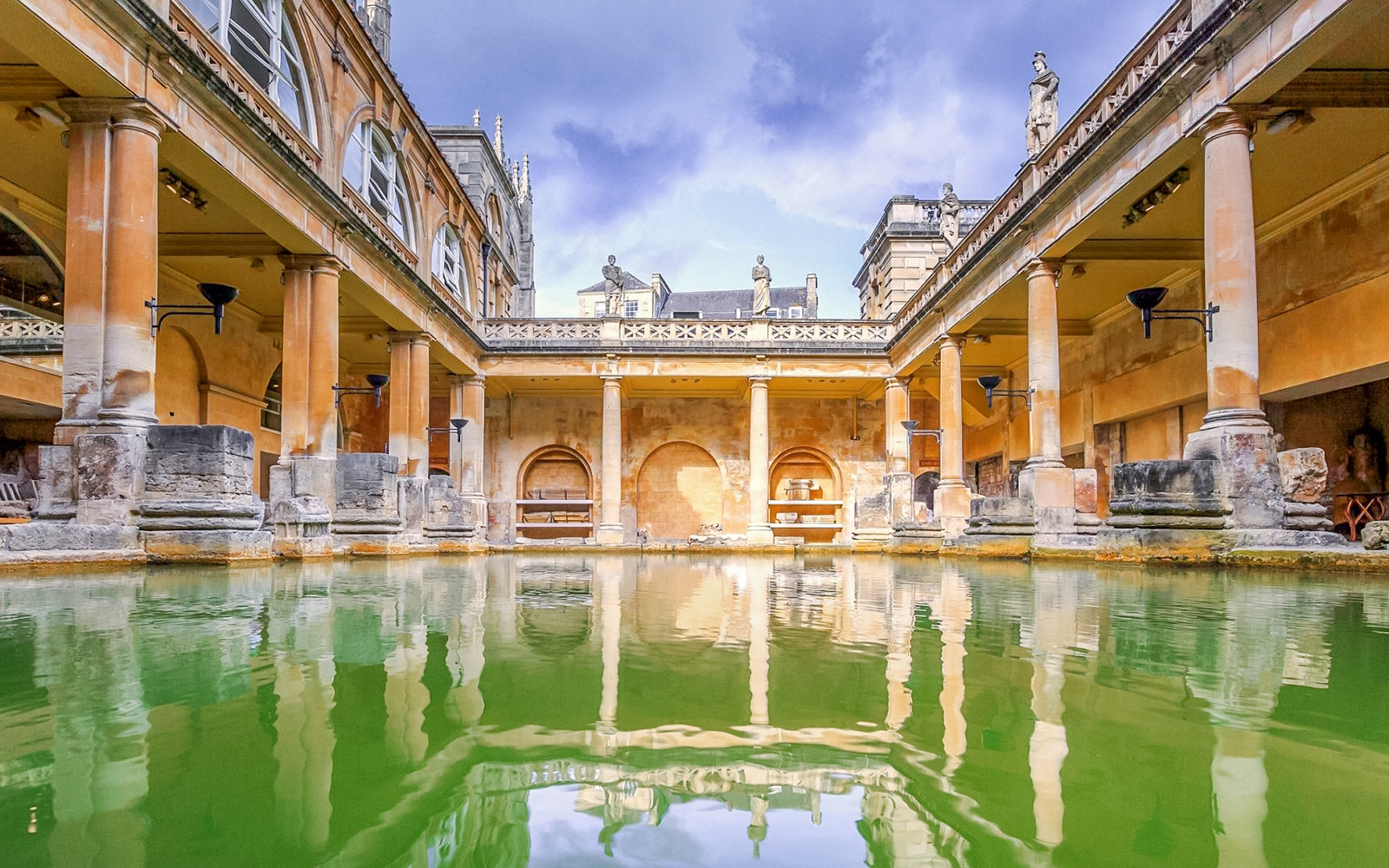 Roman Baths with columns and statues in Bath, England.
