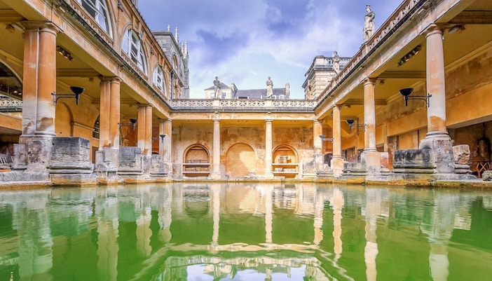 Roman Baths with columns and statues in Bath, England.