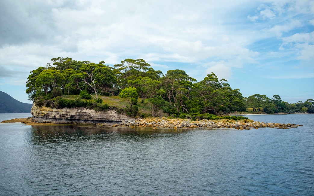 Port Arthur coastal landscape with rocky shoreline and lush greenery.