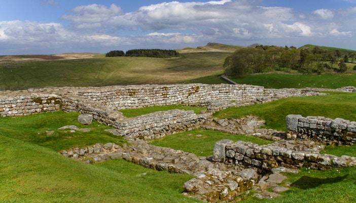 Housesteads Roman Fort ruins on Hadrian's Wall, Northumberland, England, showcasing ancient stone structures.