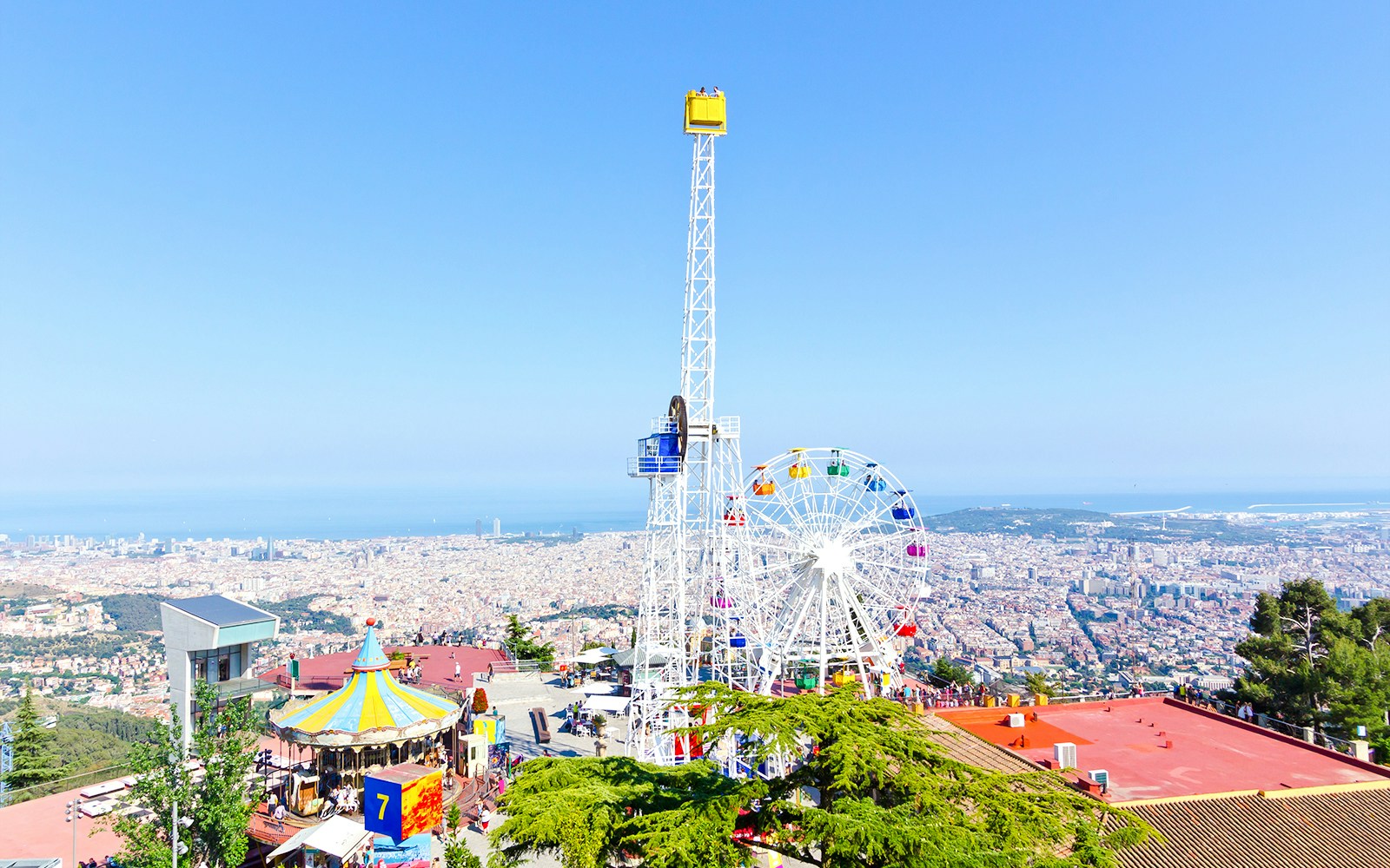 Tibidabo Amusement Park rides with panoramic views of Barcelona, Spain.