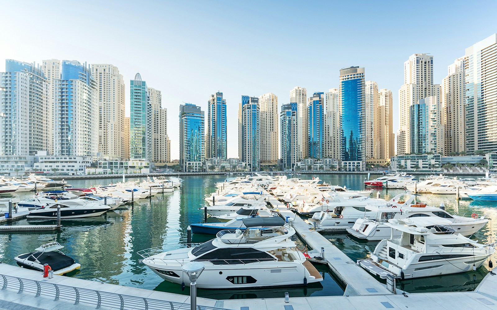 Dubai Marina Yacht Club with luxury yachts docked along the waterfront.