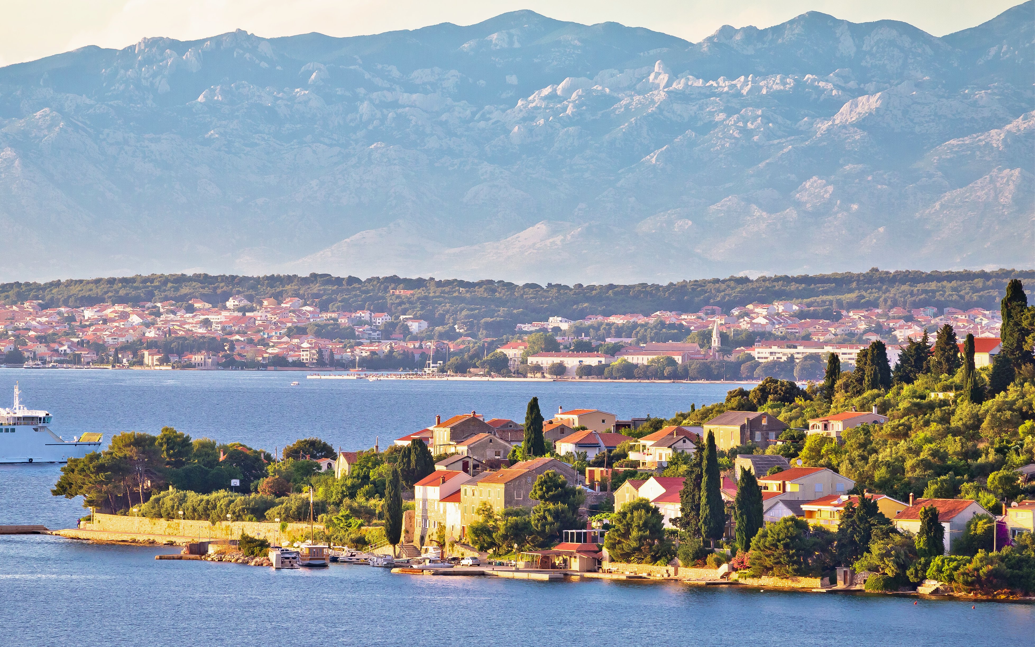 Small island of Osljak with view of Zadar city and mountains in the Zadar archipelago.