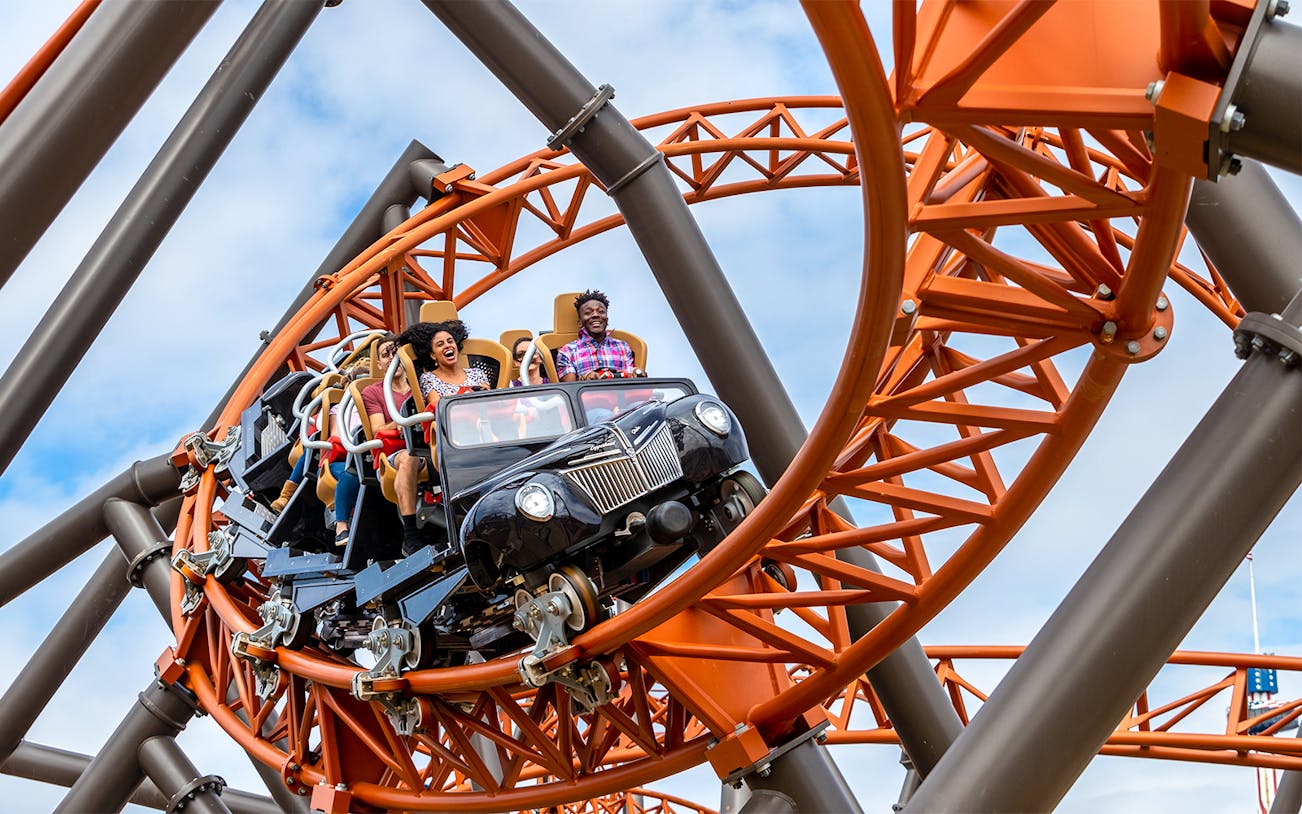 Riders on Copperhead Strike roller coaster at Six Flags Carowinds.