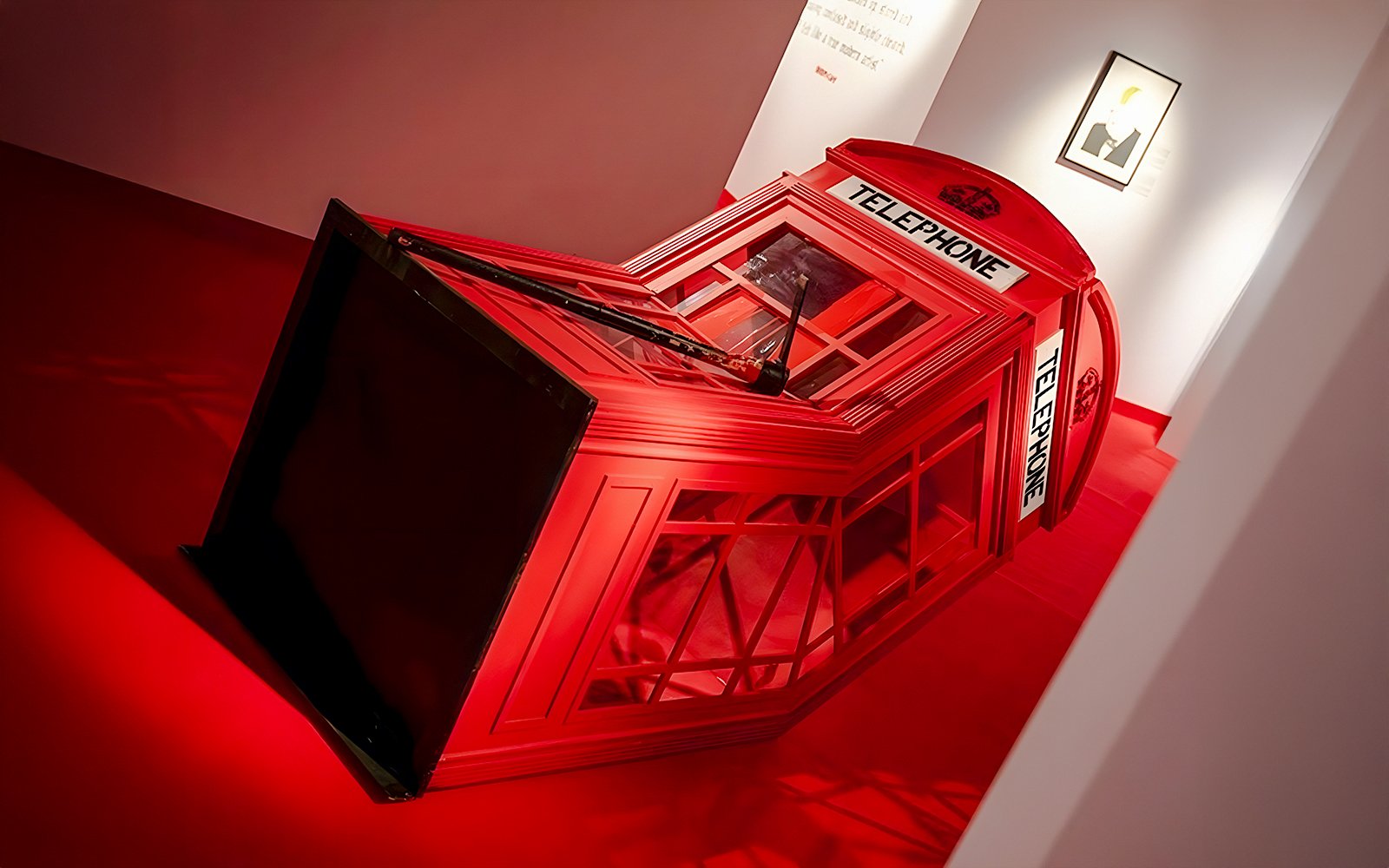 Red telephone booth installation at Banksy Limitless Exhibition.
