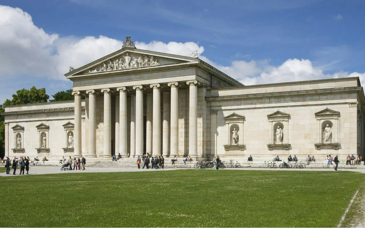 Neoclassical building with columns in Munich, part of self-guided city exploration game.