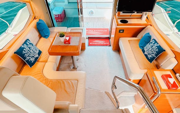 Luxury yacht interior with seating area and table, Dubai.