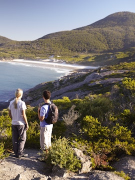 Two hikers overlooking the coastline at Wilsons Promontory National Park.