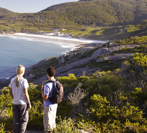 Two hikers overlooking the coastline at Wilsons Promontory National Park.