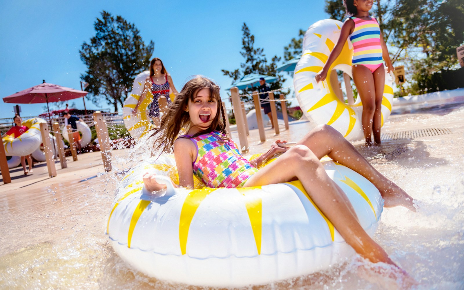 Girl enjoying water slide on tube at Walt Disney World Resort, Orlando.