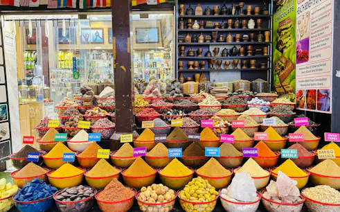 Spice market display with colorful spices and herbs in Dubai during a city tour from Abu Dhabi.