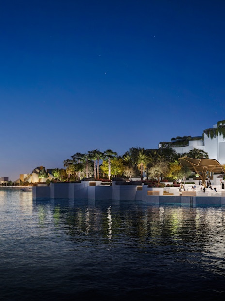 Aerial view of the National History Museum Abu Dhabi illuminated at night.