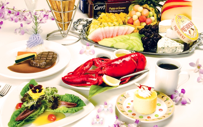 Dinner spread featuring lobster, steak, salad, and dessert on the Star of Honolulu, Three Star.
