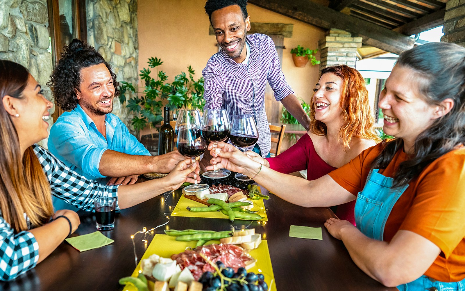 Group enjoying wine and local cuisine at a Sardinia farm-to-table restaurant.