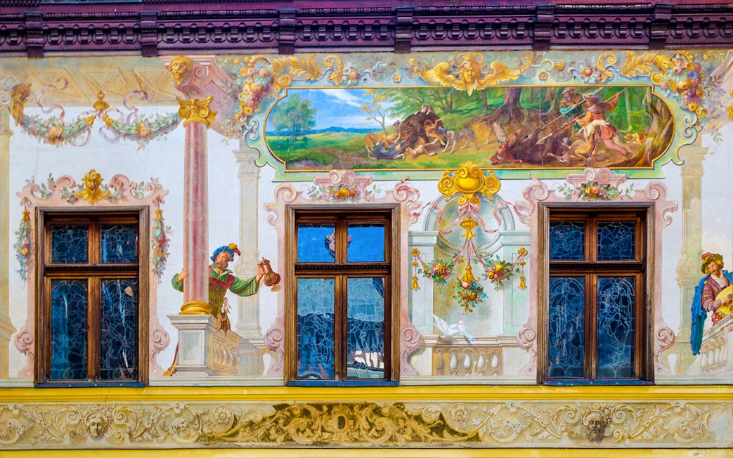 Frescos depicting hunting scenes and figures inside Peles Castle, Romania.