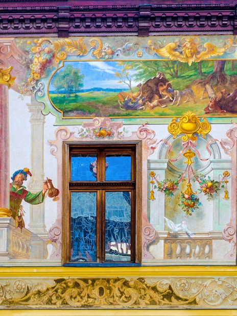 Frescos depicting hunting scenes and figures inside Peles Castle, Romania.