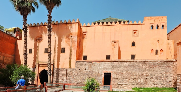 Saadian Tombs courtyard with palm trees and historic architecture in Marrakech, Morocco.