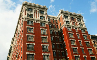 Historic red brick building in New York, part of the Mob Hits & Hangouts self-guided city exploration game.