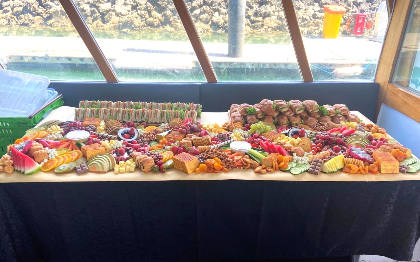 Canapés and assorted snacks on a table during Auckland Harbour cruise.