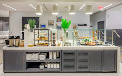 Buffet area at Aspire Lounge, San Diego International Airport, featuring snacks and beverages.