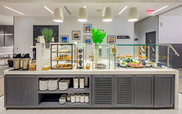 Buffet area at Aspire Lounge, San Diego International Airport, featuring snacks and beverages.