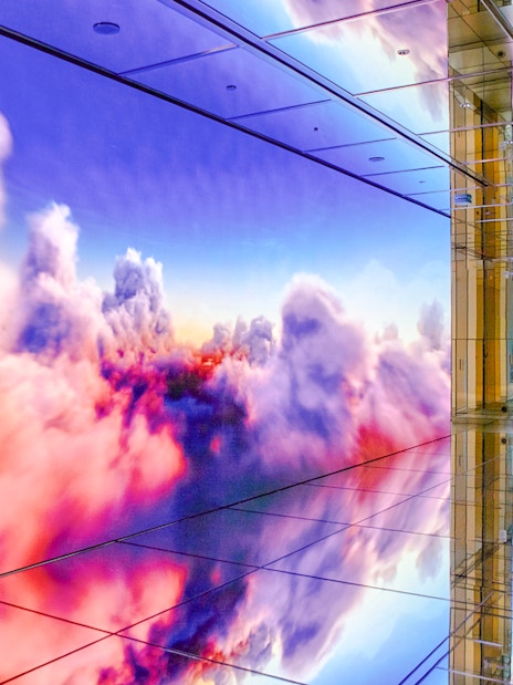 Interior of SUMMIT One Vanderbilt observation deck with mirrored floors and digital cloud display, New York City.