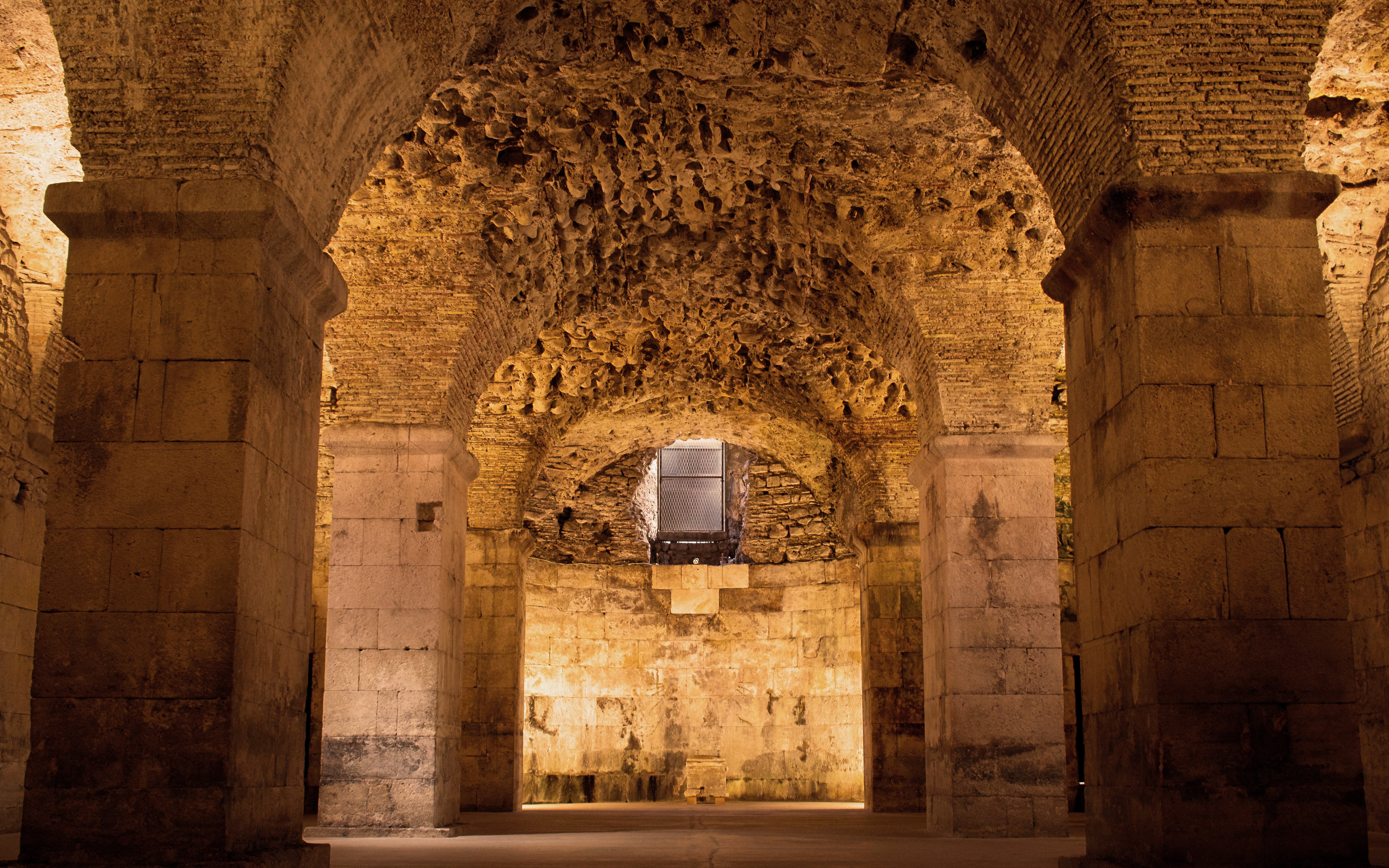 Basement catacombs of Diocletian’s Palace in Split with stone arches and columns.