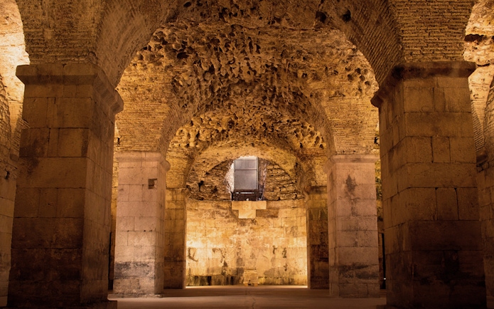 Basement catacombs of Diocletian’s Palace in Split with stone arches and columns.