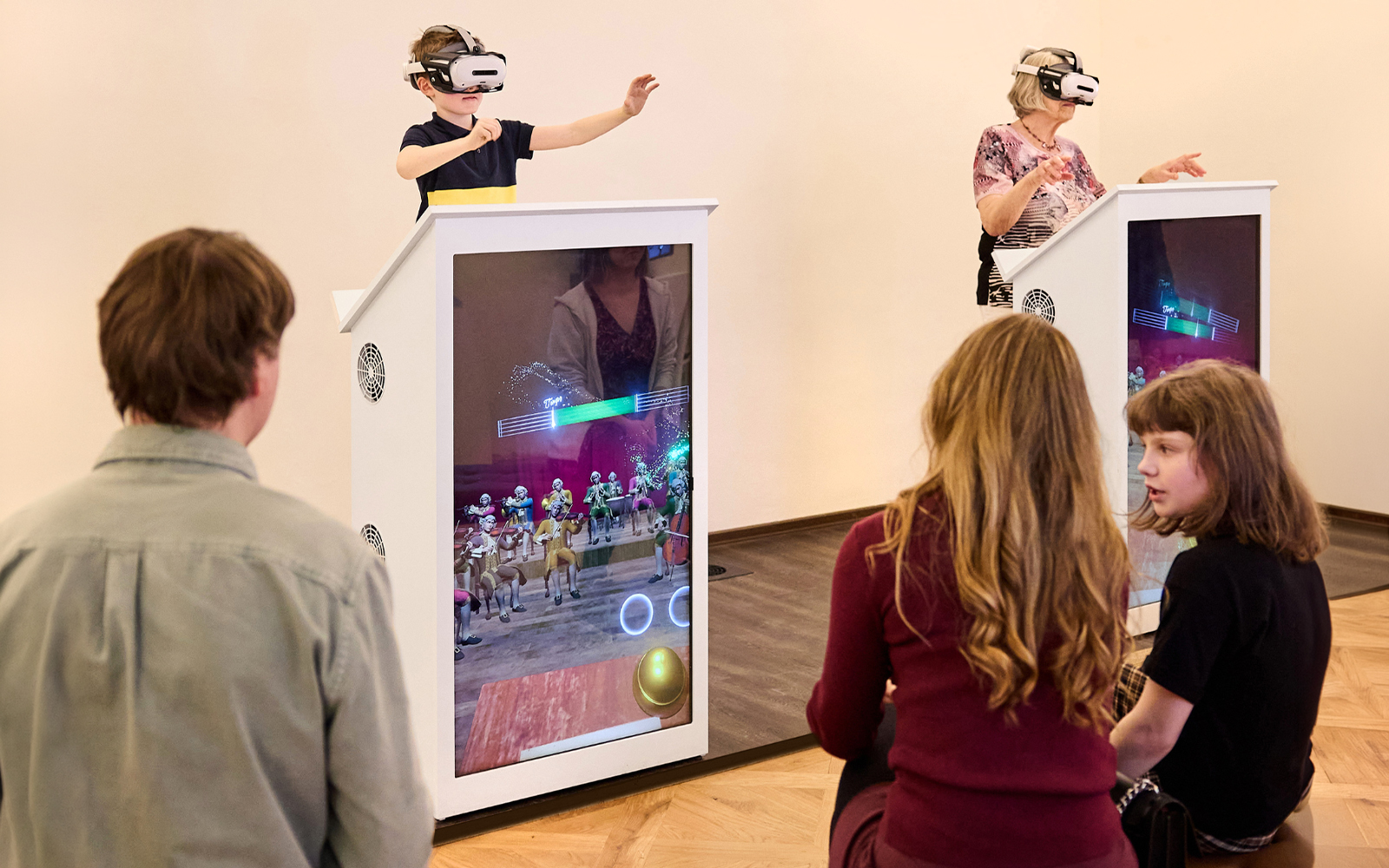 Visitors using VR at Prague Mozart Interactive Museum exhibit.