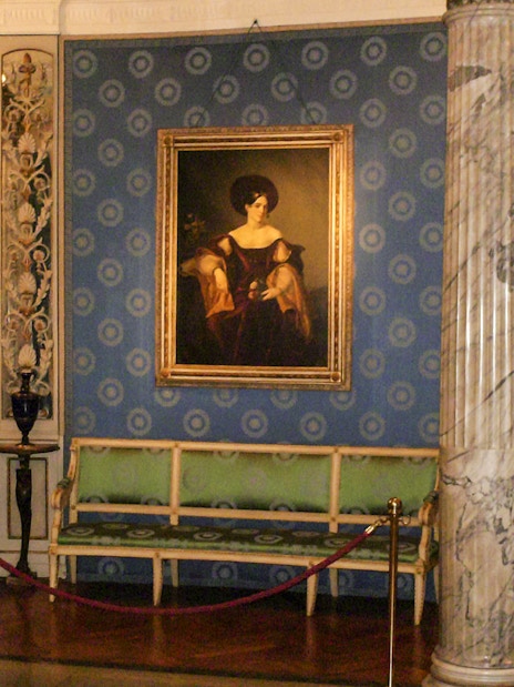 La Scala interior with paintings and marble columns on guided tour.