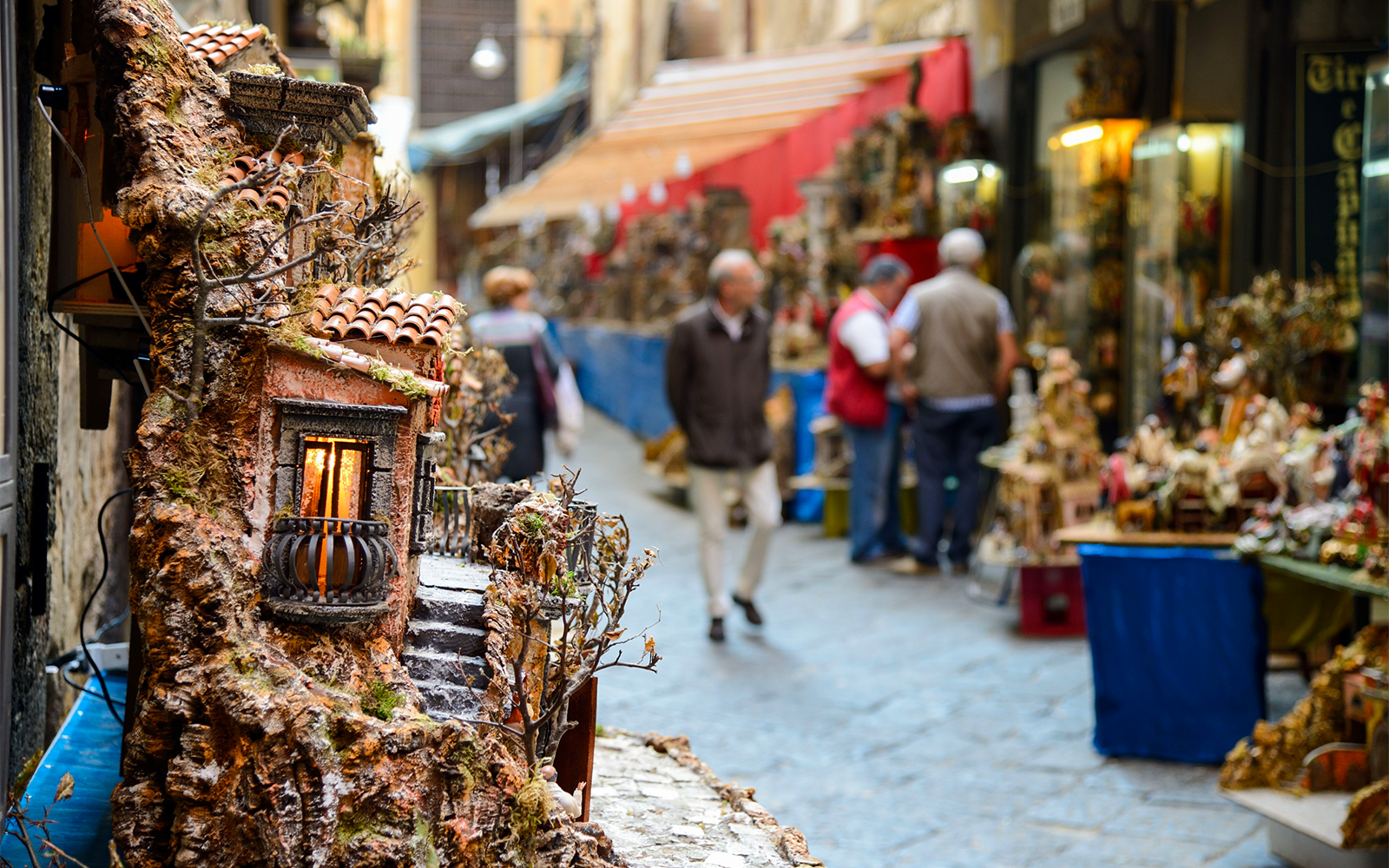 San Lorenzo Market stalls with ruins and local goods in Italy.