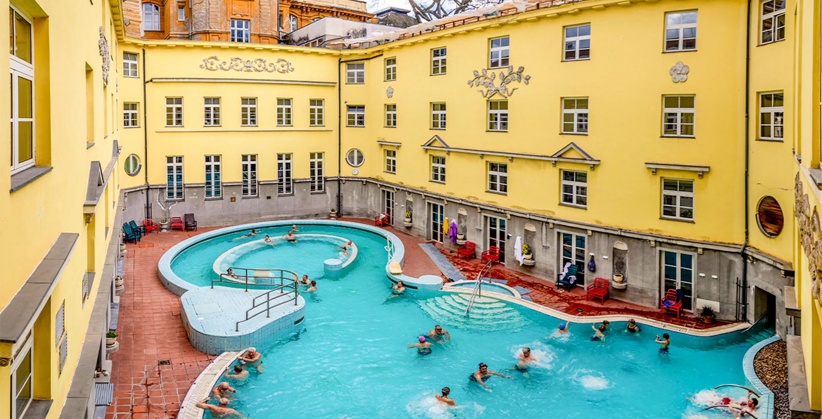 Visitors enjoying the outdoor pool at Lukács Thermal Bath, Budapest.