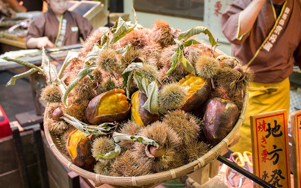 Basket of roasted chestnuts at Nishiki Market, Kyoto, during Kennin-ji Temple tour.