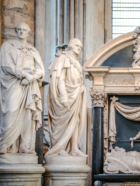 Tomb and statues in Poets' Corner, Westminster Abbey, London.