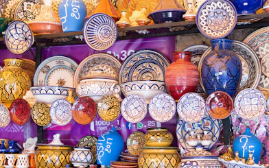 Moroccan ceramics display with colorful plates and vases in traditional patterns.