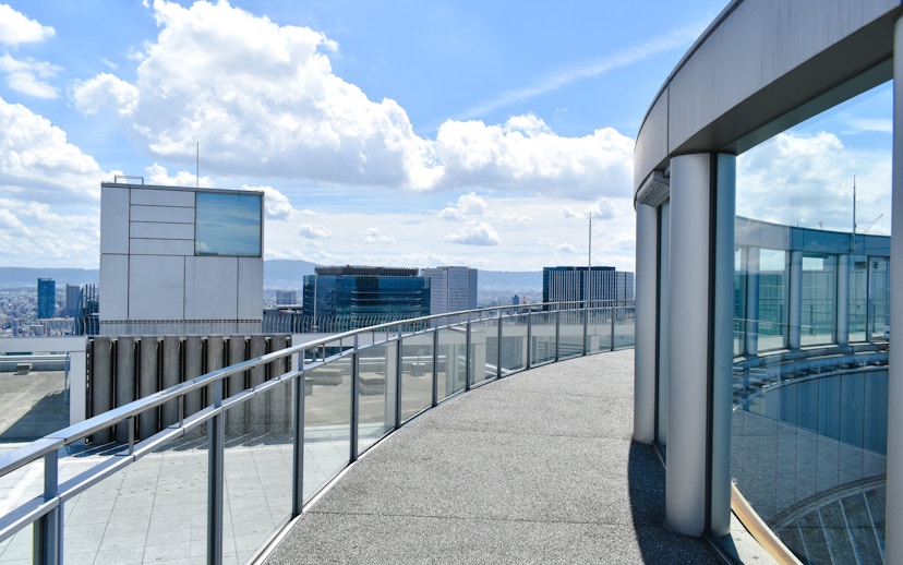 Rooftop view from Umeda Sky Building in Osaka, showcasing city skyline and modern architecture.