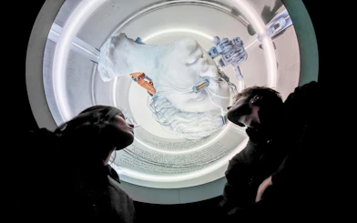 Visitors observing a futuristic art installation at Mercer Labs Museum of Art.