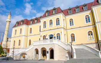 Kosovo Museum building with arched entrance and staircase in Pristina.