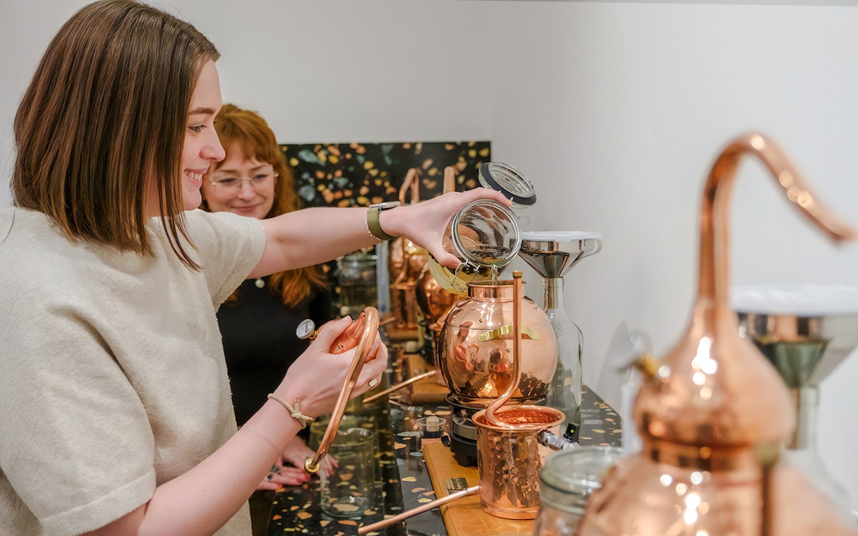 Guests participating in gin making with copper stills in Edinburgh.