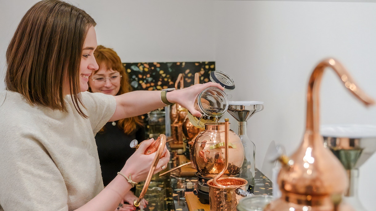 Guests crafting gin at a distillery in Edinburgh during a hands-on gin making experience.