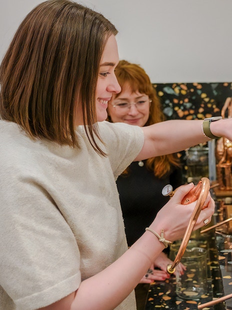 Guests participating in gin making with copper stills in Edinburgh.