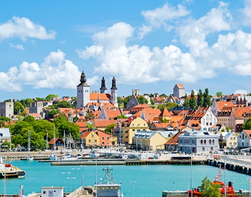 Red double-decker bus on a New Orleans street, part of the City Sightseeing 1-Day Hop-On Hop-Off Bus Tour.