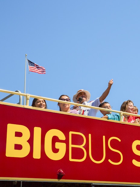 Tourists on San Francisco Big Bus tour with Alcatraz view.