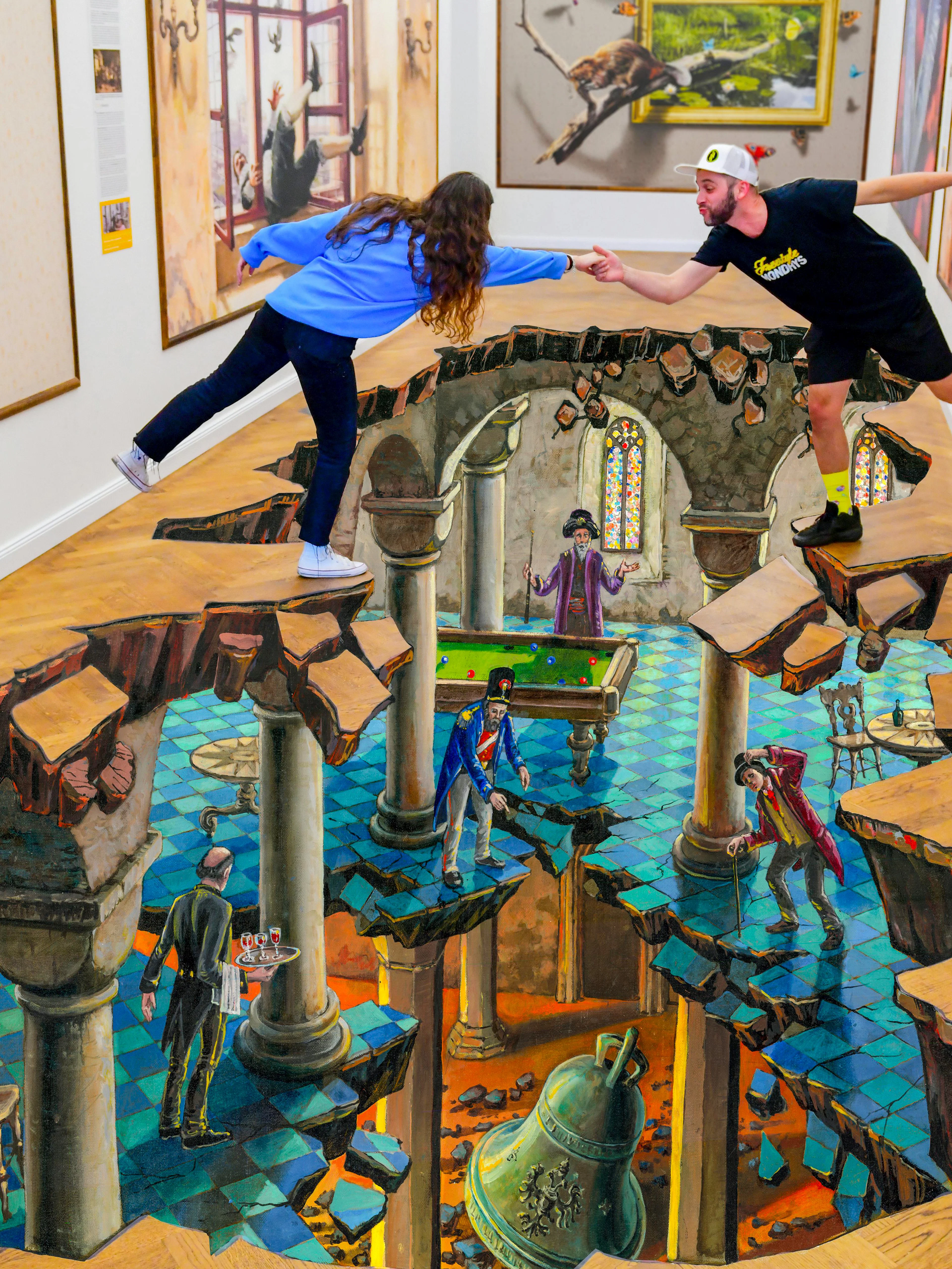 Visitors interacting with 3D floor art at IAM Illusion Art Museum, Prague.