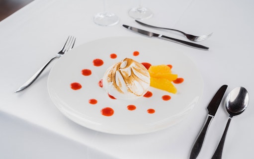 Dessert with meringue and orange slices on Bateaux Mouches Seine River Lunch Cruise.