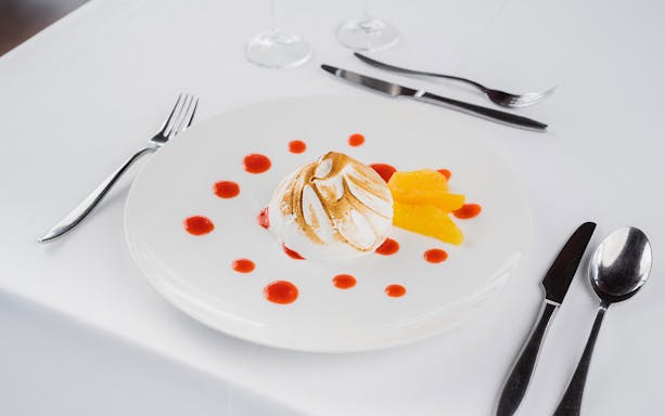 Dessert with meringue and orange slices on Bateaux Mouches Seine River Lunch Cruise.