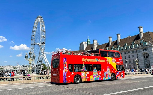 Red double-decker bus near the London Eye on the Thames River cruise tour.
