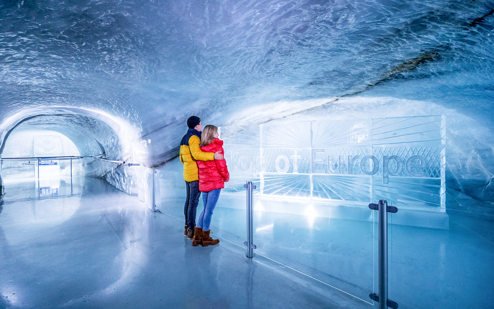 Couple exploring Ice Palace at Jungfraujoch, Switzerland.